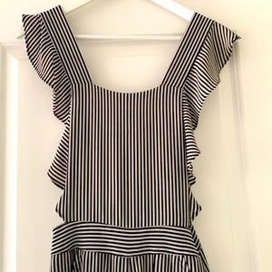 Dressy overalls style jumpsuit, black and white striped with adjustable straps